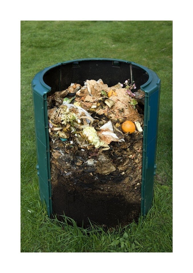 Compost bin full of food waste as it naturally turns into compost